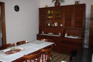 a dining room with a table and a cabinet at B&B Da Roby in Corinaldo
