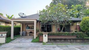 a house with a bench in front of it at Happy house @ Casa Seaside Rayong in Ban Chak Phai