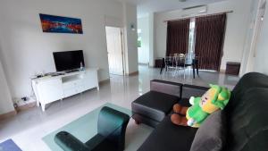 a living room with a couch with a stuffed toy at Happy house @ Casa Seaside Rayong in Ban Chak Phai
