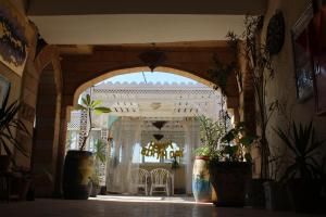 an entrance to a room with chairs and plants at Osiris Hotel Cairo in Cairo