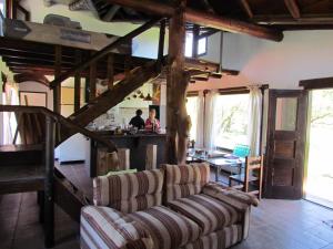 a living room with two couches and a kitchen at Cabañas San Miguel in Cortaderas