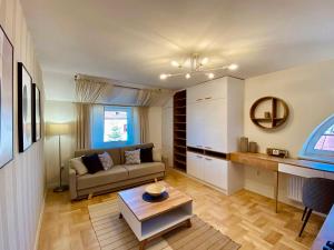 a living room with a couch and a table at Apartamenty na Klasztornej in Jasło