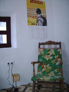 una silla sentada en una habitación con un cartel en la pared en Wunderschönes Ferienhaus in Andalusien en Montejaque