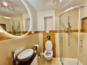 a bathroom with a sink toilet and a shower at Apartamenty na Klasztornej in Jasło