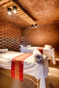 a room with three beds in a room with brick walls at Casa de Agua in Tepoztlán +51 photos
