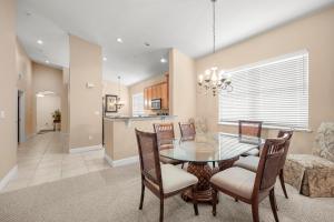 a dining room and kitchen with a table and chairs at 561 Cinnamon Beach in Palm Coast +40 photos