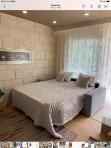 a bedroom with a large bed and a window at Sole in Makarska