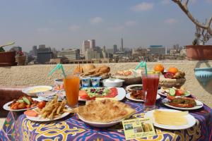 a table with plates of food and drinks on it at Osiris Hotel Cairo in Cairo