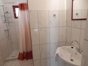 a bathroom with a shower and a sink at Napsugár Apartman in Baja