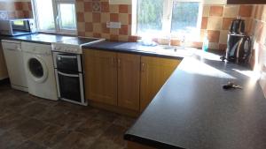 a kitchen with a washer and dryer on a counter at Sligo Wild Atlantic Cottage in Sligo