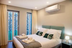 En eller flere senge i et værelse på Alcântara Factory II