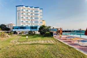 a hotel with a swimming pool and a resort at Hotel Asiago Beach in Lido di Savio