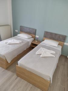 two beds sitting next to each other in a room at Chriselia House in Nea Roda
