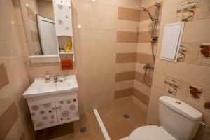 a bathroom with a toilet and a sink and a shower at Your place in Plovdiv