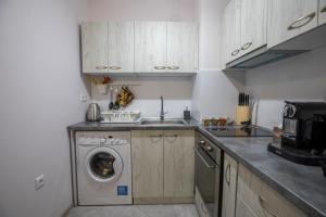 a kitchen with a washing machine and a washer at Your place in Plovdiv