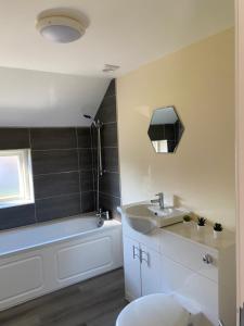 a bathroom with a sink and a bath tub at Hodge Bower Holidays, Ironbridge - Blades in Ironbridge