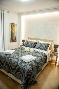 a bedroom with a large bed with two towels on it at Helen's Little Castle free private parking in Thessaloniki