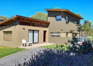 a house with a car parked in front of it at Casa Barrio Acantilados proxima al mar in Mar del Plata