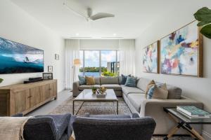 a living room with a couch and a table at Cayman Luxury Rentals at One Canal Point in Upper Land