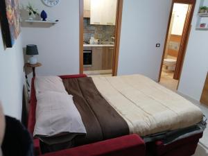 a bedroom with a bed in a room with a kitchen at STONE HOUSE e Casa Vacanze Zia Rosina in Montemaggiore Belsito