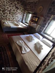 a bedroom with two beds with shoes on them at Bayiri Petit Pension in Litochoro