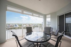 a room with a glass table and chairs on a balcony at 952 Cinnamon Beach, Sleeps 6, 3 Bedroom, WiFi, Elevator, 2 Pools in Palm Coast
