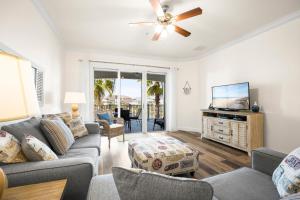 a living room with a couch and a flat screen tv at 1032 Cinnamon Beach, 3 Bedrooms, Elevator, 2 Heated Pools, Spa, Wifi, New HDTV, Sleeps 6 in Palm Coast
