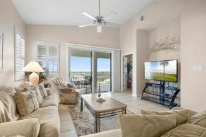 a living room with a couch and a tv at 1061 Cinnamon Beach, 3 Bedroom, Sleeps 8, 2 Pools, Elevator, Pet Friendly in Palm Coast