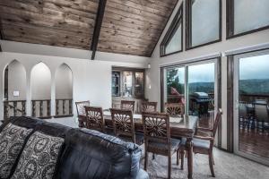 a living room with a table and chairs at White Mountain Chateau in Ruidoso