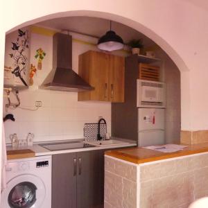 a kitchen with a sink and a washing machine at CASITA LUAN in Tragacete +24 photos