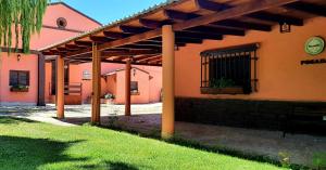 an orange building with a pergola on the side of it at Museo Posada Benelli in San Rafael
