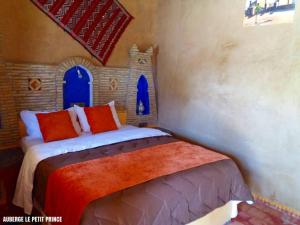 a bedroom with a bed in a castle themed room at Hotel Riad Le Petit Prince in Merzouga