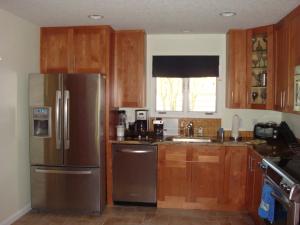 a kitchen with wooden cabinets and a stainless steel refrigerator at Ponte Vedra Players Club Villa 17, Players Club Pool, 3 Bedrooms, Sleeps 6 in Ponte Vedra