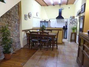 a kitchen and dining room with a table and chairs at Cal Pedrellar in Colldejou