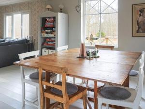 a dining room with a wooden table and chairs at 6 person holiday home in RONNEBY-By Traum in Ronneby