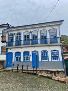 Casa azul y blanca con balcón en Caminhos da Liberdade Pousada, en Ouro Preto