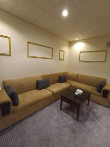 a living room with a couch and a coffee table at Saryet Al Hamra Hotel Apartments in Jeddah