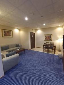 a living room with a couch and a table at Saryet Al Hamra Hotel Apartments in Jeddah