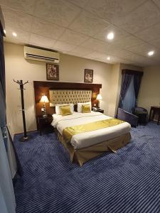 a bedroom with a large bed in a room at Saryet Al Hamra Hotel Apartments in Jeddah