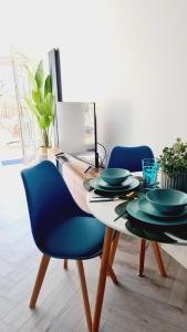 a dining room with a table with blue chairs at Beautiful 2bed house with garden, walking distance to town - FREE parking in Glasgow