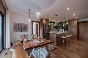 a kitchen with a wooden table and chairs and a counter at High Loop in Ruidoso