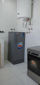 a kitchen with a small refrigerator and a stove at MBAO Sipres Appartement moderne bord de mer in Mbaw