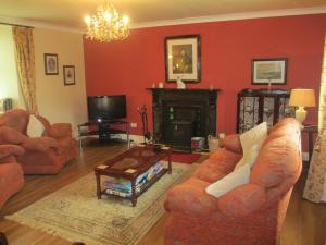 a living room with two couches and a fireplace at Tralia Farmhouse Self Catering in Farranfore