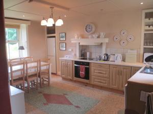 a kitchen with a sink and a stove top oven at Tralia Farmhouse Self Catering in Farranfore