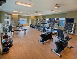 a gym with several treadmills and elliptical machines at 1000 Islands Harbor Hotel in Clayton