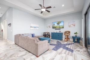 a living room with a couch and a ceiling fan at Cinnamon Beach Nautilus in Palm Coast