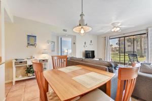 a dining room and living room with a table and chairs at Ocean Village Club N14, 1 Bedroom, Sleeps 4, Heated Pool, Pet Friendly, WiFi in Saint Augustine