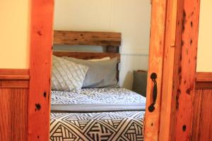a bedroom with a bunk bed with a wooden frame at The Cottage in Bairnsdale