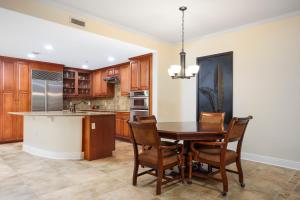 a kitchen with a dining room table and chairs at Palm Coast Resort 109 in Palm Coast