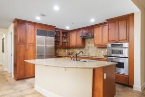 a kitchen with wooden cabinets and a granite counter top at Palm Coast Resort 109 in Palm Coast